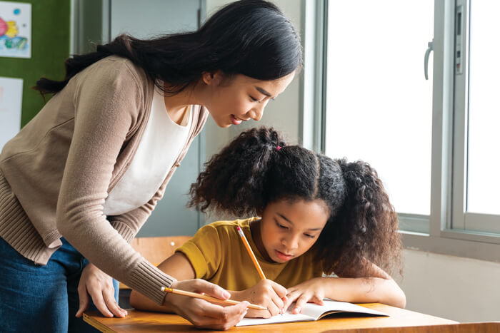 Parent helping child with homework.