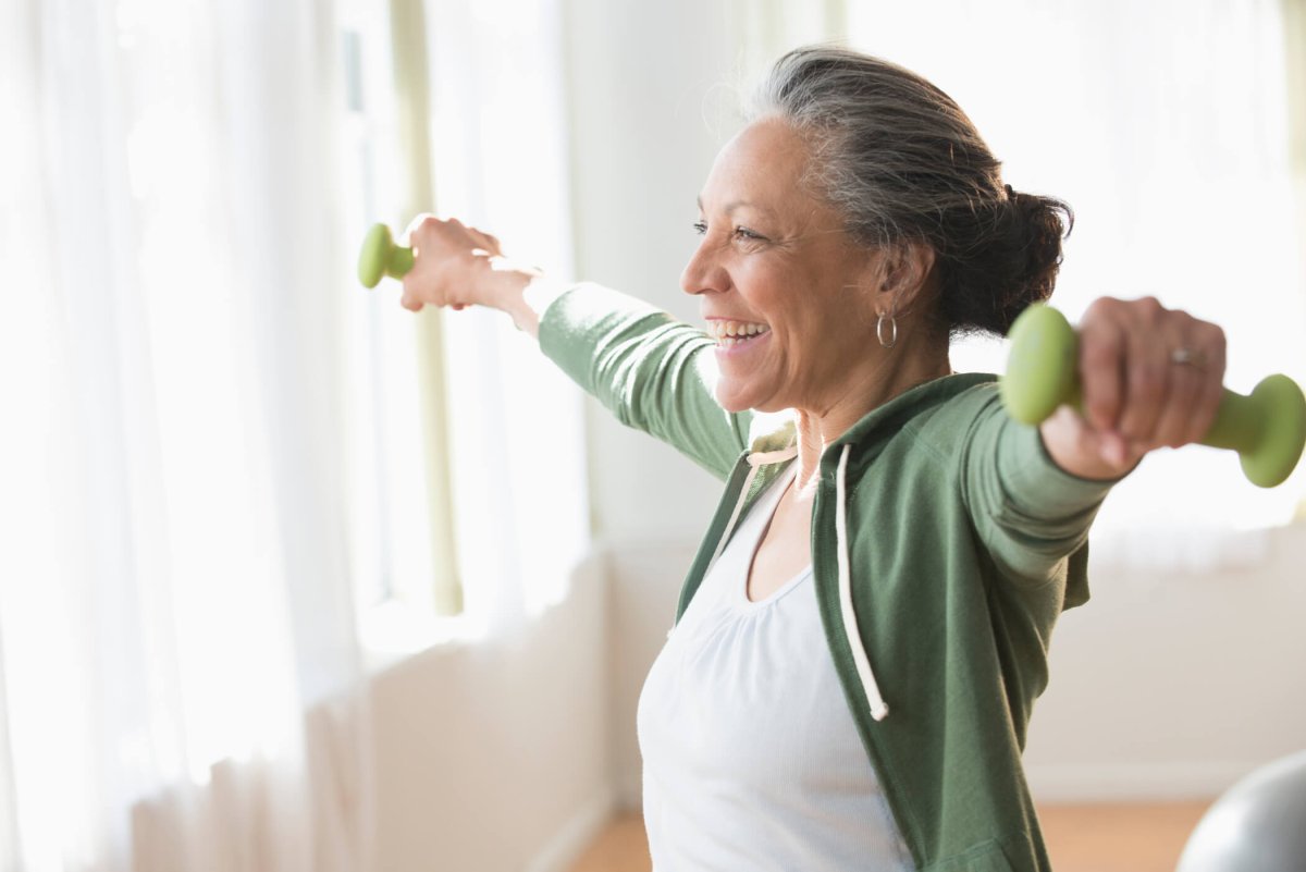 A woman working out with hand weights